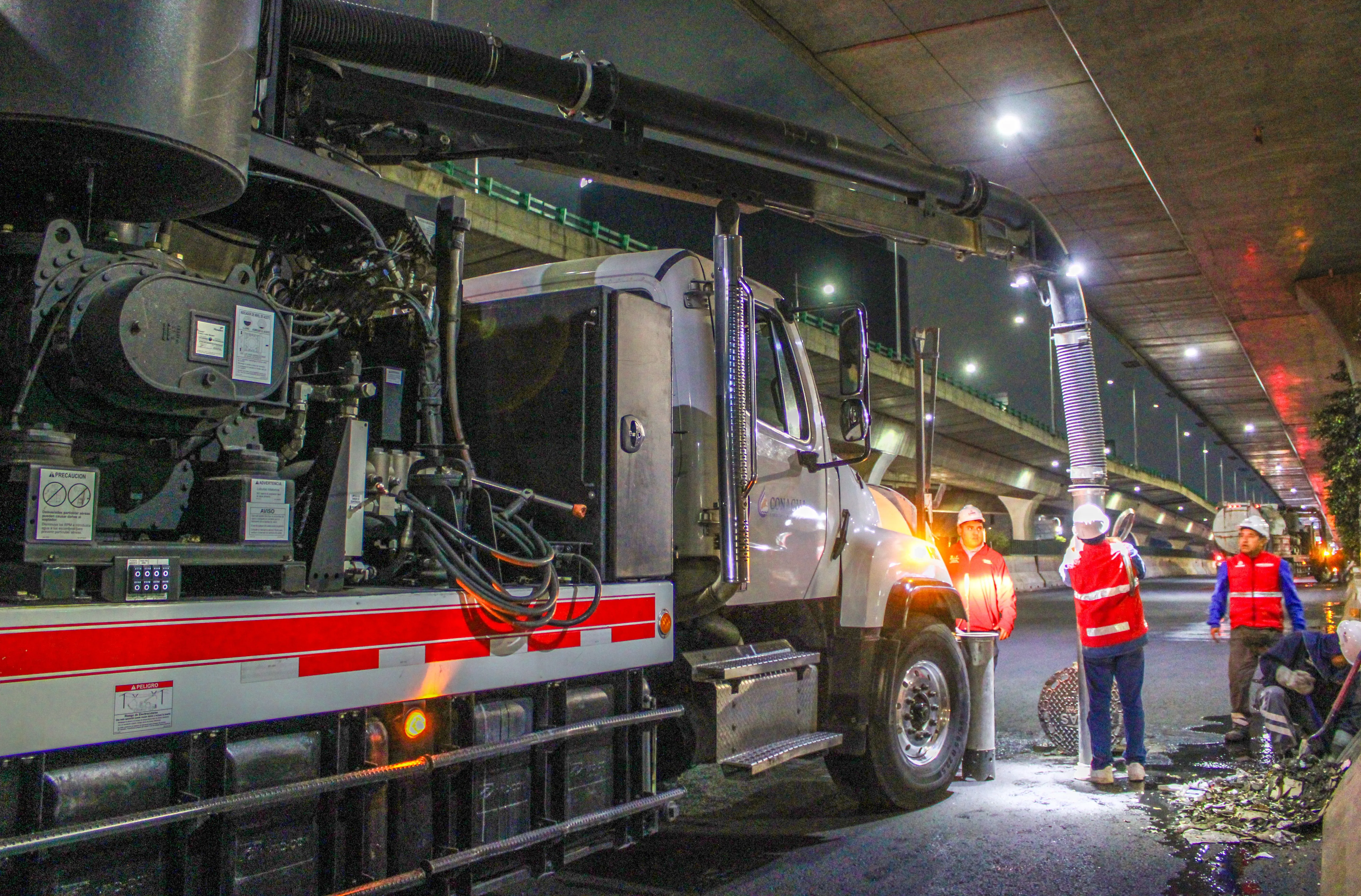 Workers using vacuum truck